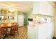 Bright kitchen with light green cabinets, a round dining table, and modern appliances at 116 W Saint Johns Way, Apollo Beach, FL 33572