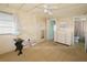 Bedroom with light walls, dresser, and access to the bathroom at 116 W Saint Johns Way, Apollo Beach, FL 33572