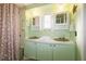 Updated bathroom with double vanity and shower/tub combo at 116 W Saint Johns Way, Apollo Beach, FL 33572