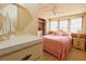 Spacious main bedroom with a pink comforter, and plenty of natural light at 116 W Saint Johns Way, Apollo Beach, FL 33572