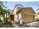 Tan two-story house with a two-car garage and landscaping at 17539 Balmaha Dr, Land O Lakes, FL 34638