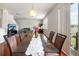 Dining area with glass table, view to living room and backyard at 17539 Balmaha Dr, Land O Lakes, FL 34638