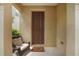 Front door entryway with a chair and welcome mat at 17539 Balmaha Dr, Land O Lakes, FL 34638