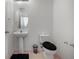 Clean bathroom with pedestal sink and oval mirror at 17539 Balmaha Dr, Land O Lakes, FL 34638