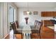 Dining room with glass table and view to backyard at 17539 Balmaha Dr, Land O Lakes, FL 34638