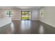 Spacious living area with dark hardwood floors and sliding glass doors at 7203 S De Soto St, Tampa, FL 33616