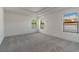 Bright bedroom with grey carpet and large windows at 7203 S De Soto St, Tampa, FL 33616