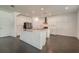 Modern kitchen with white cabinets, large island, and stainless steel appliances at 7203 S De Soto St, Tampa, FL 33616