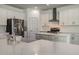 Modern kitchen with white cabinets, stainless steel appliances, and large island at 7203 S De Soto St, Tampa, FL 33616