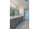Bathroom with dual vanity, grey cabinets, and quartz countertops at 7203 S De Soto St, Tampa, FL 33616