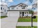 Two-story modern farmhouse style home with dark metal roof at 7203 S De Soto St, Tampa, FL 33616