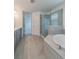 Spa-like bathroom with soaking tub, walk-in shower, and dual vanity at 7203 S De Soto St, Tampa, FL 33616