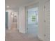 Hallway with carpet and access to bedrooms and bathroom at 7203 S De Soto St, Tampa, FL 33616
