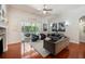 Open living space with hardwood floors, comfortable seating, and pool access at 19211 Pelican Ridge Ln, Tampa, FL 33647