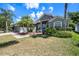 Gray house with palm trees and landscaped yard at 19211 Pelican Ridge Ln, Tampa, FL 33647