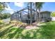 Screened-in pool with lush landscaping and a large backyard at 19211 Pelican Ridge Ln, Tampa, FL 33647