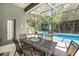 Screened pool area with patio furniture and a view of lush greenery at 19211 Pelican Ridge Ln, Tampa, FL 33647
