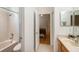 Clean bathroom with a shower/tub combo, vanity, and view of bedroom at 19211 Pelican Ridge Ln, Tampa, FL 33647