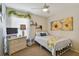 Bedroom with a queen bed, dresser, and sunflower art at 36140 Shady Bluff Loop, Zephyrhills, FL 33541