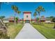 Community clubhouse with palm trees and walkway at 36140 Shady Bluff Loop, Zephyrhills, FL 33541