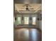 Spacious living room with bay windows, hardwood floors, and ceiling fan at 3008 N Nebraska Ave, Tampa, FL 33603