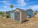 Tan and gray plastic storage shed in backyard at 199 S Port Royal Ln, Apollo Beach, FL 33572