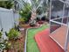 Landscaped backyard with a fire pit, walkway, and tropical plants at 1209 Croydonwood Cir, Brandon, FL 33510