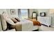 Bright bedroom with a queen-size bed and dresser at 1041 Capri Isles Blvd # 219, Venice, FL 34292