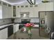 Modern kitchen with white cabinets and granite countertops at 1041 Capri Isles Blvd # 219, Venice, FL 34292