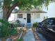 Quaint white house with a black door and small front yard at 406 S Orleans Ave, Tampa, FL 33606