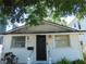 Quaint white house with a black door and small front porch at 406 S Orleans Ave, Tampa, FL 33606
