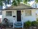 White cottage with black door, small yard at 406 S Orleans Ave, Tampa, FL 33606