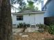 Small white house with a front patio and landscaping at 406 S Orleans Ave, Tampa, FL 33606