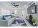 Bright living room featuring a fireplace, comfortable seating, and large TV at 7608 20Th Nw Ave, Bradenton, FL 34209
