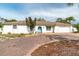 White single story home with a teal door, brick driveway, and lush landscaping at 7608 20Th Nw Ave, Bradenton, FL 34209