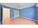 Spacious bedroom featuring hardwood floors, a ceiling fan and a closet with ample storage space at 2620 Locksley St # 261, Sun City Center, FL 33573