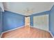 Bedroom featuring hardwood floors, a ceiling fan and a spacious closet, offering comfort and convenience at 2620 Locksley St # 261, Sun City Center, FL 33573