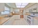 Well-lit kitchen featuring white appliances, tiled flooring, and ample countertop space at 2620 Locksley St # 261, Sun City Center, FL 33573