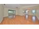 Open living room with hardwood floors, large windows and a view to the outdoors, creating a warm ambiance at 2620 Locksley St # 261, Sun City Center, FL 33573