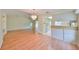 Open living room with chandelier, laminate floor, and access to the kitchen at 2620 Locksley St # 261, Sun City Center, FL 33573
