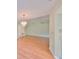 Bright living room with laminate flooring and a decorative chandelier at 2620 Locksley St # 261, Sun City Center, FL 33573