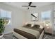 Cozy bedroom featuring neutral tones, two windows for natural light, and modern nightstands with stylish lamps at 325 33Rd N Ave, St Petersburg, FL 33704