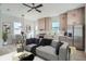 Contemporary living room with stylish gray sofa, modern light fixtures, and an adjacent kitchen and dining area at 325 33Rd N Ave, St Petersburg, FL 33704