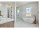 Spa-like bathroom with soaking tub, walk-in shower, and modern vanity at 325 33Rd N Ave, St Petersburg, FL 33704
