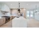 Modern kitchen with island, stainless steel appliances, and light wood cabinets at 325 33Rd N Ave, St Petersburg, FL 33704