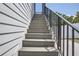 Gray composite deck stairs with black metal railing at 325 33Rd N Ave, St Petersburg, FL 33704