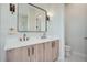 Double vanity bathroom with light wood cabinets and quartz countertops at 325 33Rd N Ave, St Petersburg, FL 33704
