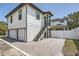 Two-car garage with gray paver driveway and exterior stairs at 325 33Rd N Ave, St Petersburg, FL 33704
