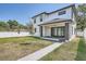 Landscaped backyard with a walkway leading to a two story home at 325 33Rd N Ave, St Petersburg, FL 33704