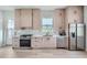 Modern kitchen with light wood cabinets and stainless steel appliances at 325 33Rd N Ave, St Petersburg, FL 33704
